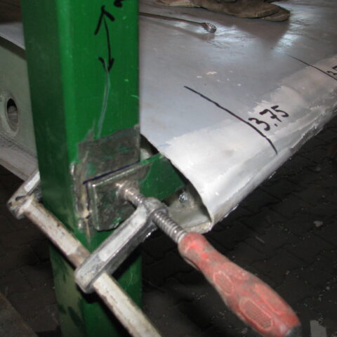 A piece of metal is attached to the side of a pole.