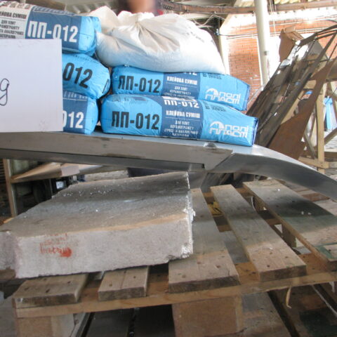 A pallet of cement and bags on top of pallets.