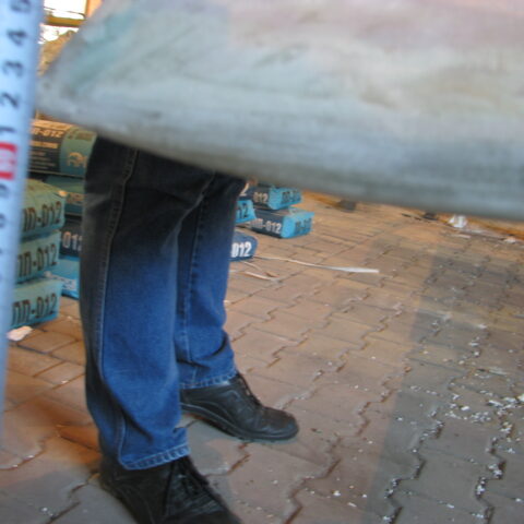A person standing on the ground with their feet up.