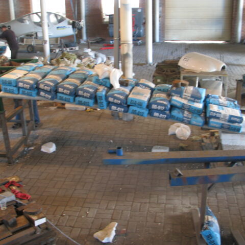 A large amount of toilet paper is on the conveyor belt.