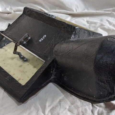 A black bag with a piece of paper on it