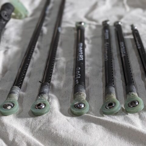 A group of six different sized rods on top of a white cloth.