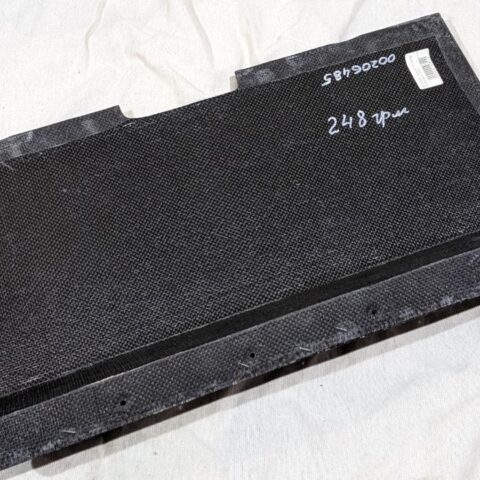 A black box sitting on top of a bed.