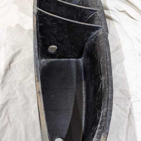 A black object sitting on top of a white sheet.