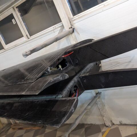 A couple of black boats sitting on top of a floor.