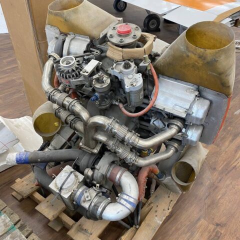 A car engine sitting on top of a wooden table.